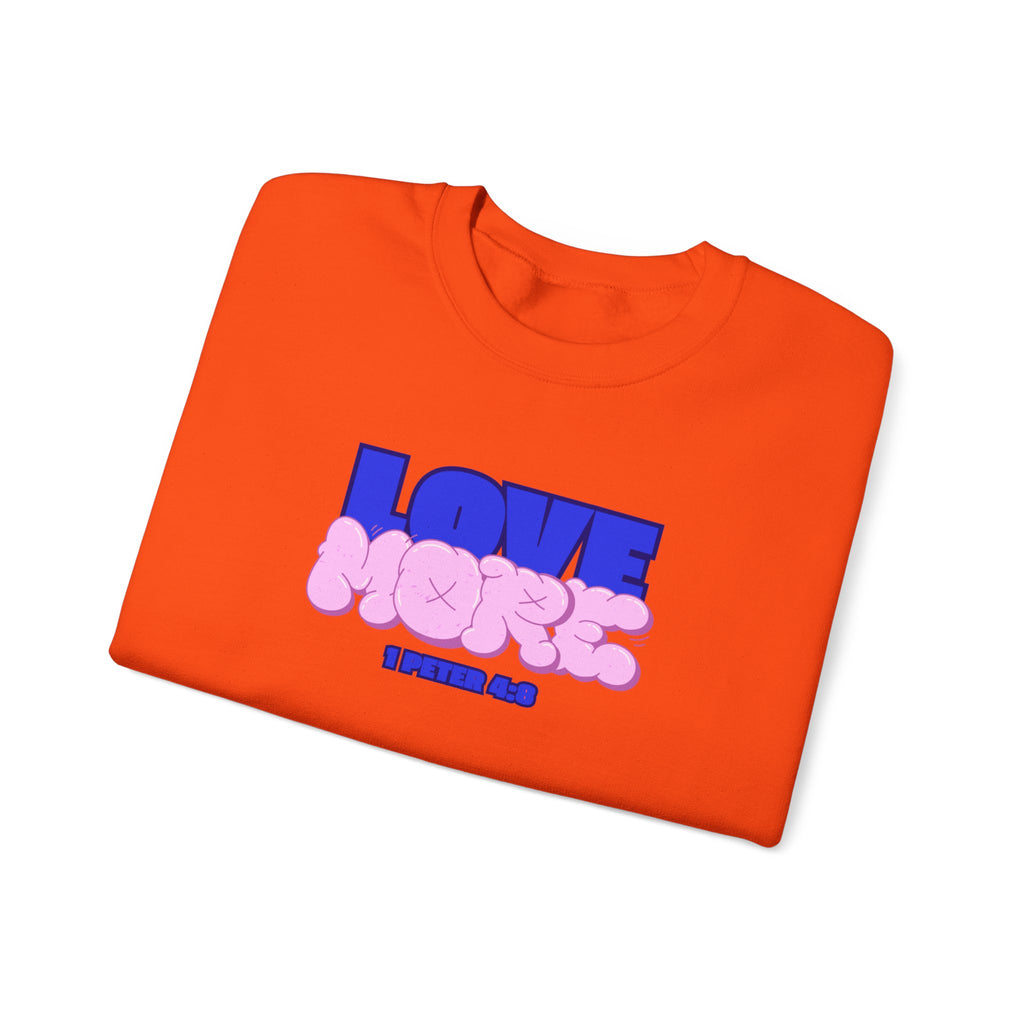 Orange crewneck sweater with long sleeves; pink LOVE graphic and small text on front