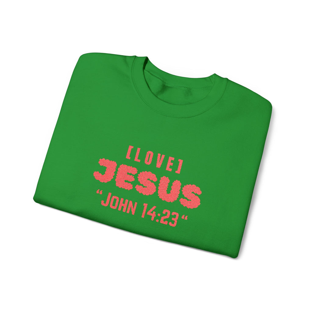 Green crewneck sweater with red 'I LOVE JESUS' and 'JOHN 14:23' print.